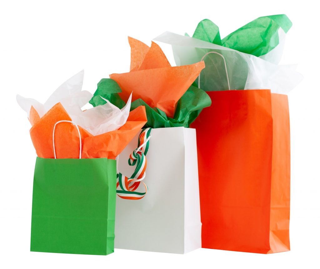St. Patrick's Day Packaging Collection- St. Patrick’s Day packaging collection featuring green, white, orange, and gold paper bags, luxury wrapping paper, and tissue paper