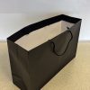 Black luxury paper carrier bag in landscape orientation with rope handles, ideal for premium retail, gifting, or branded packaging.