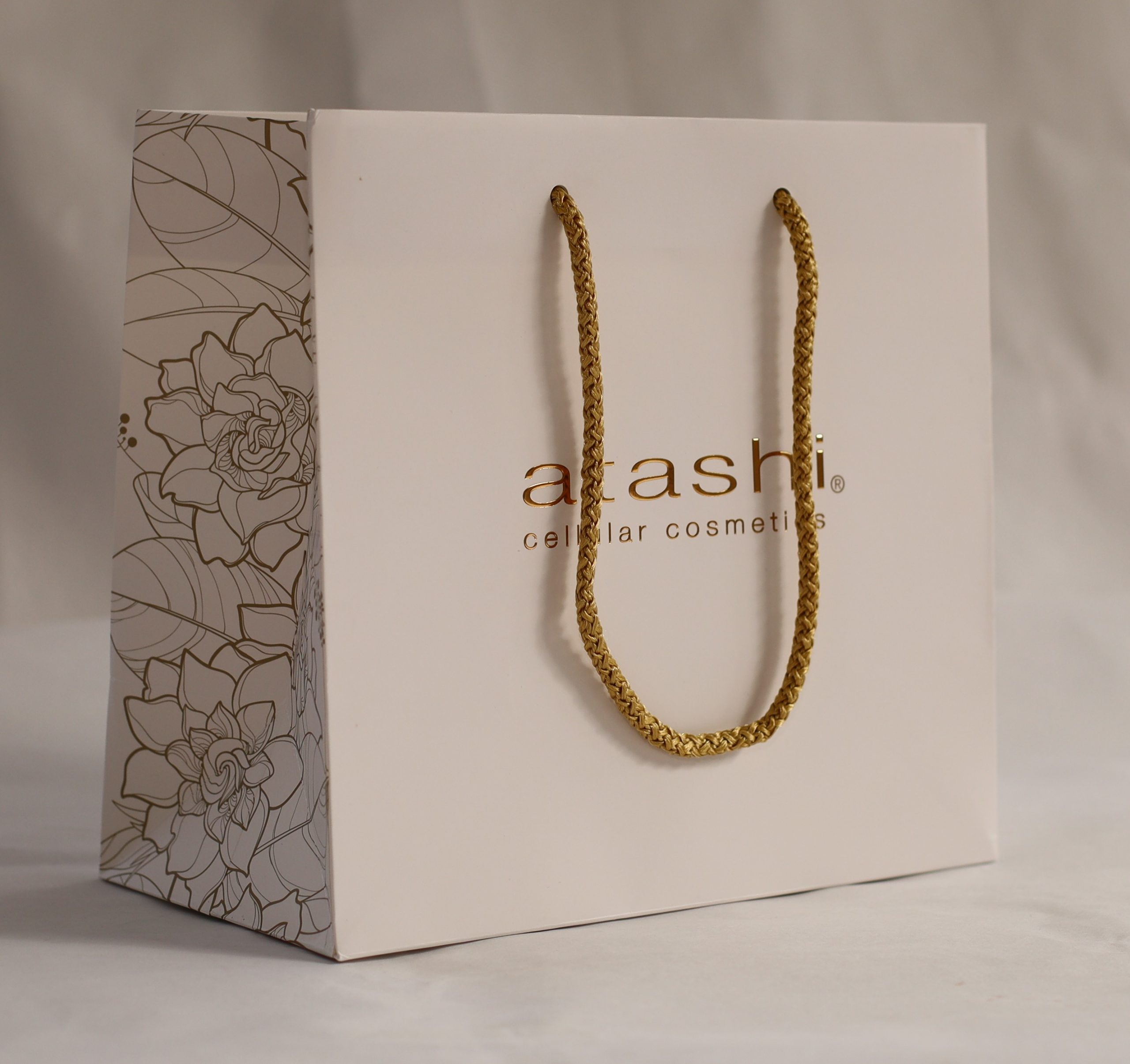 Luxury branded paper bag with gold rope handles for cosmetics and beauty retail