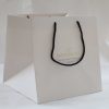 Luxury branded paper bag with ribbon handles for fashion retail