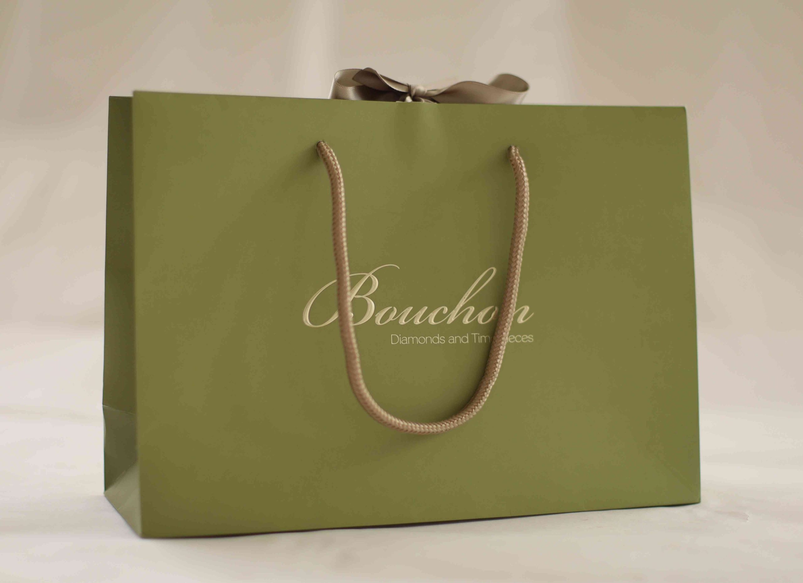 Luxury branded paper bag with rope handles and ribbon for jewellery retail