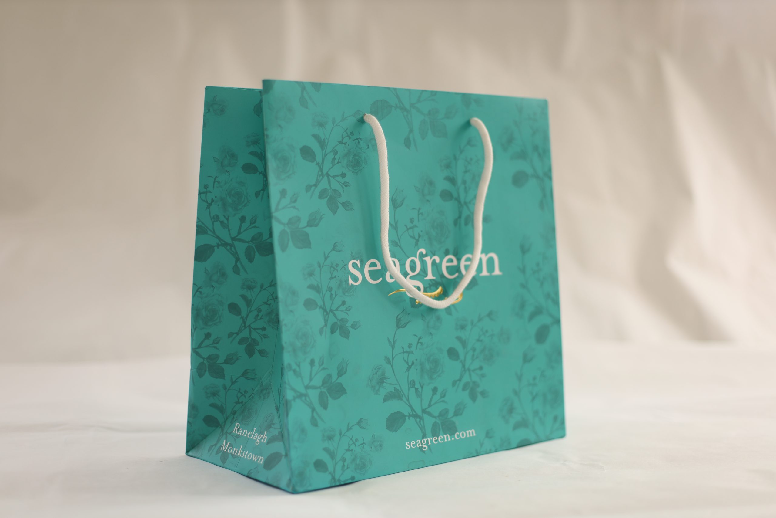 Luxury branded paper bag with patterned print and rope handles