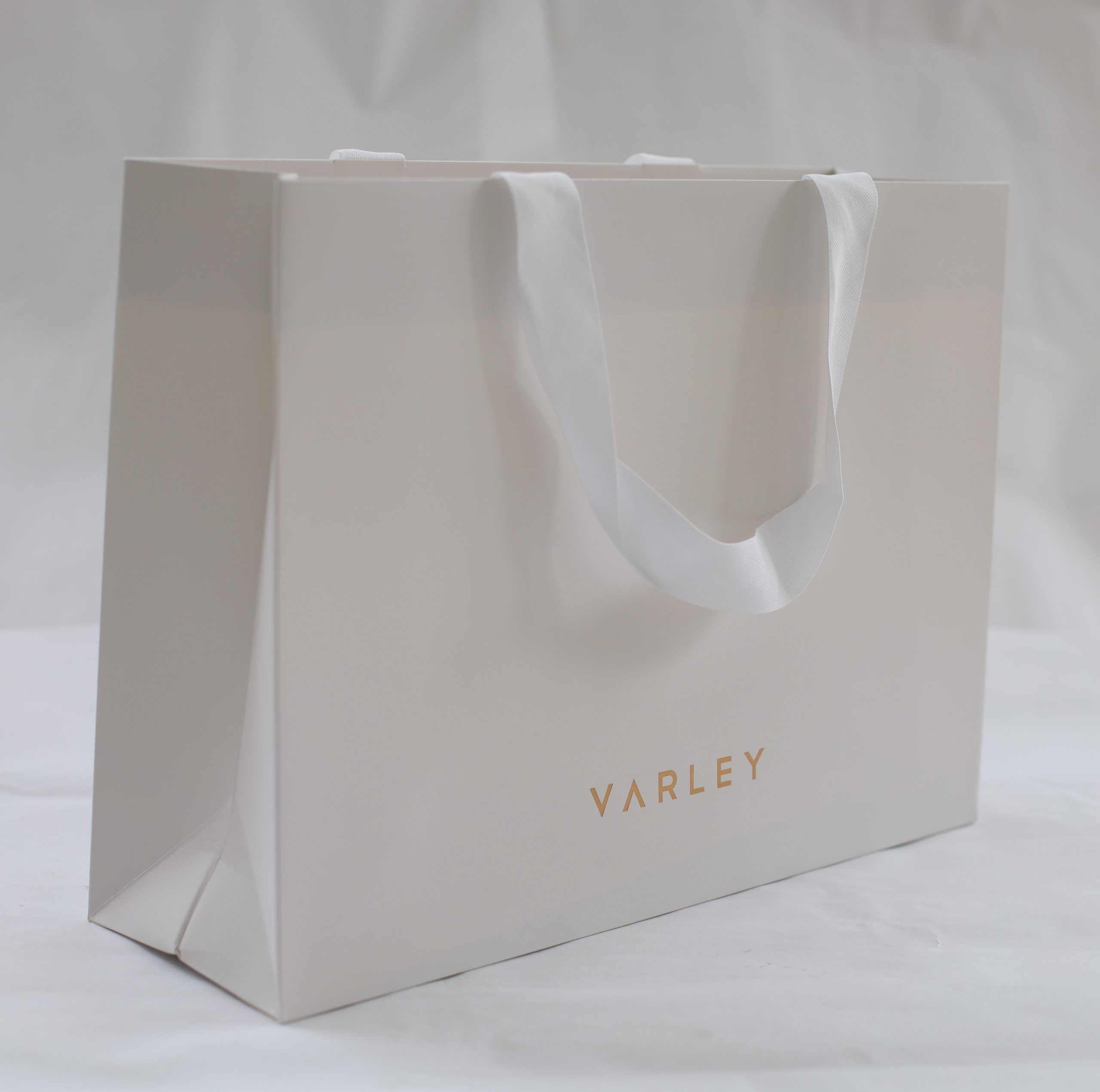 Luxury branded paper bag with rope handles for hotel and resort retail
